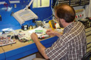 Designer using a breadboard for testing part of a client's product invention prototype