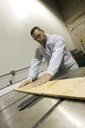 Designer using a table saw for a client's product invention