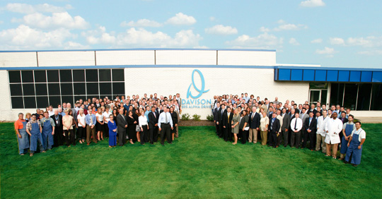 Employees standing in front of the 595 Alpha Building